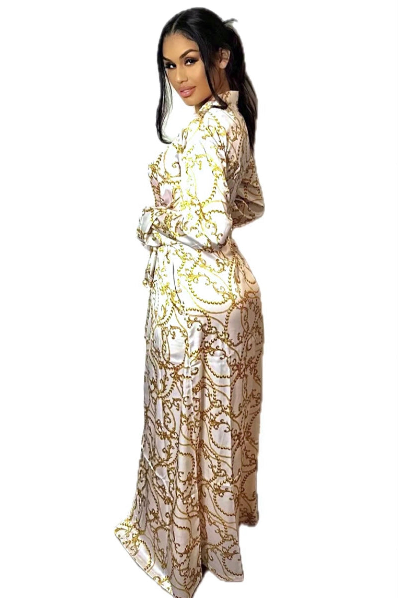 Model wearing a long, white and gold abstract duster for women, Barocco print floor length women's silky wrap dress. Luxury designer women's casual sleep and loungewear with a gold chain design.
