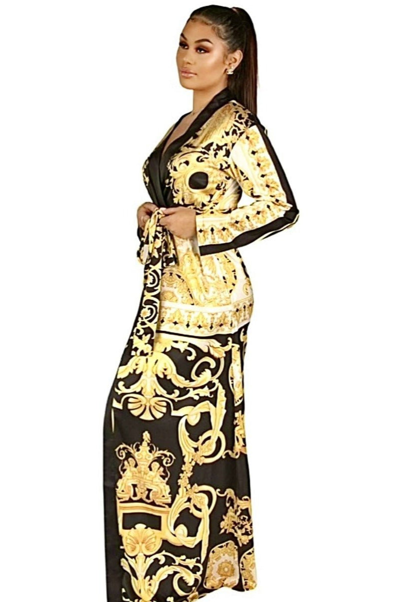Model wearing a yellow, black and white long and flowing duster style wrap dress robe housecoat with barocco print