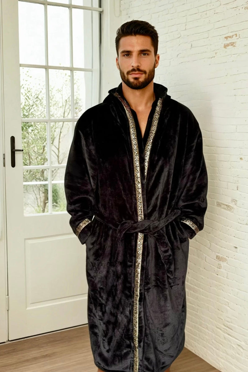 A man wearing a black hooded Royalty Robe with gold Greek key trim. Soft fleece mens bathrobe with hood and pockets.