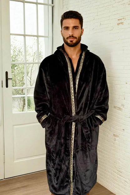A man wearing a black hooded Royalty Robe with gold Greek key trim. Soft fleece mens bathrobe with hood and pockets.