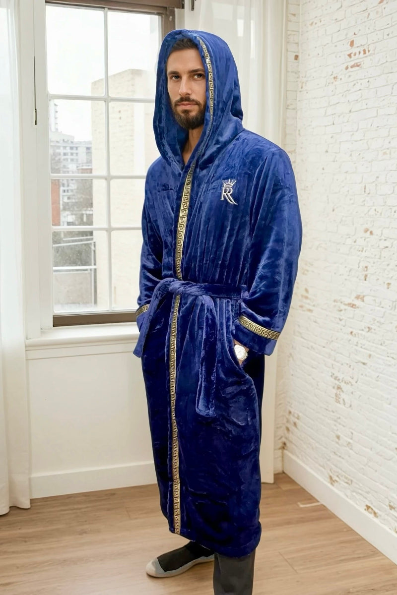 Man wearing the blue hooded Royalty Robe with gold Greek key trim and pockets. Soft fleece bathrobe with hood