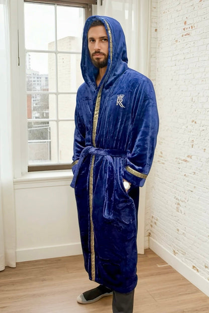 Man wearing the blue hooded Royalty Robe with gold Greek key trim and pockets. Soft fleece bathrobe with hood
