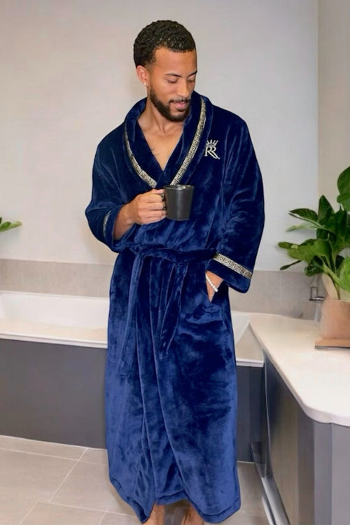 Man drinking coffee and wearing a blue robe. Dark blue, soft and cozy fleece mens bathrobe, housecoat loungewear with gold Greek key trim. Great gift for men.