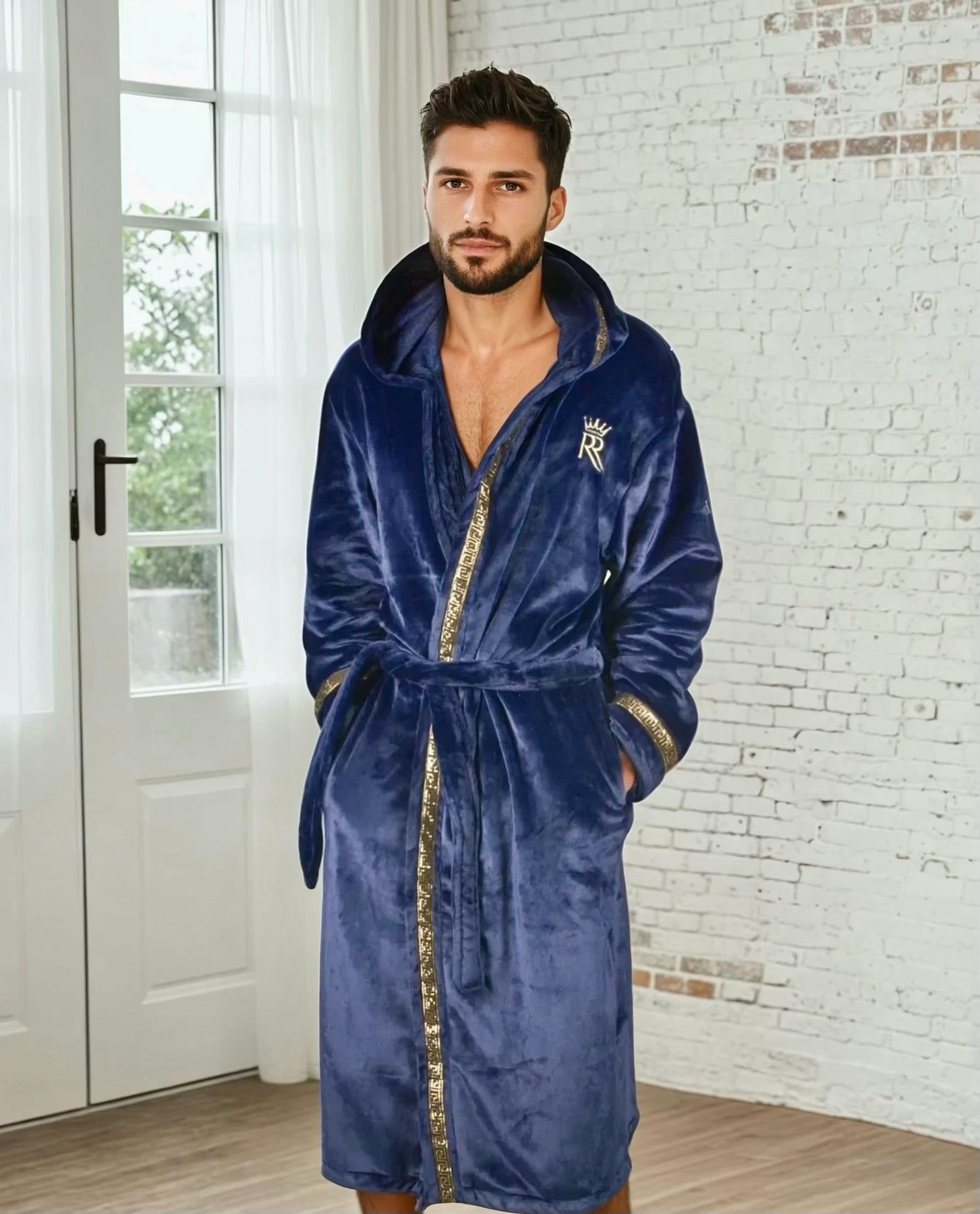 Man wearing the blue hooded Royalty Robe with gold Greek key trim and pockets. Soft fleece bathrobe with hood