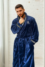 Male model wearing a blue robe. Dark blue, soft and cozy fleece mens bathrobe, housecoat loungewear with gold Greek key trim. Great gift for men. 