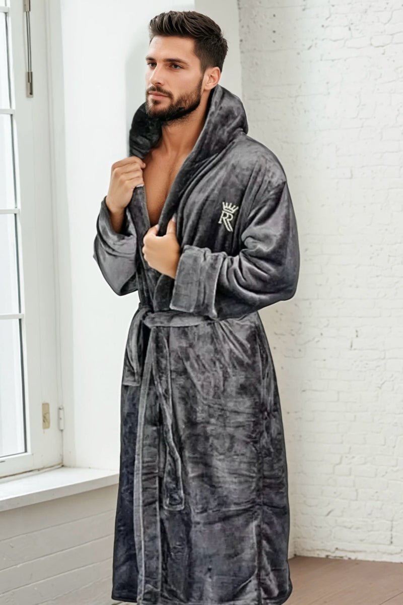 Male model wearing a soft fleece, grey bathrobe with hood. 