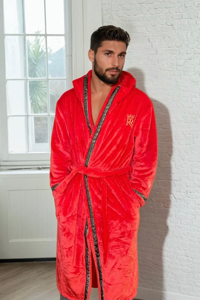 Man wearing the red hooded Royalty Robe with gold Greek key trim and pockets. Soft fleece bathrobe with hood.