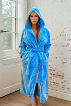 Sky Blue Hooded Royalty Robe - Royalty Robes - Model wearing a long women's bathrobe with hood and gold Greek key trim and pockets. Soft luxury robe for women.