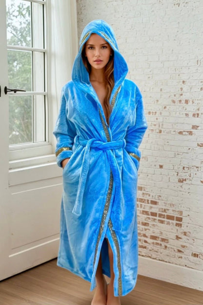 Sky Blue Hooded Royalty Robe - Royalty Robes - Model wearing a long women's bathrobe with hood and gold Greek key trim and pockets. Soft luxury robe for women.