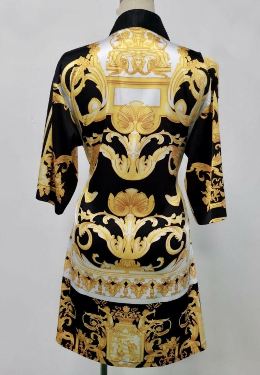 The back side of a black, yellow and white short kimono style Barocco print luxury robe 