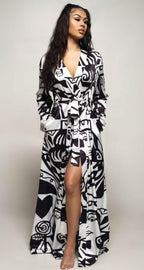 Model wearing a long flowing black and white abstract print duster style wrap dress, womens robe - housecoat for women.
